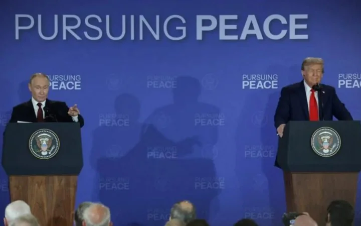 Володимир Путін і Дональд Трамп за трибунами на тлі «PURSUING PEACE» Ради миру