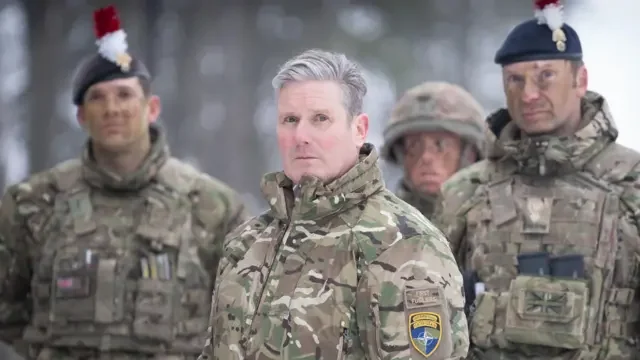 Британский министр обороны Джон Хили с военными в форме с эмблемой Украины