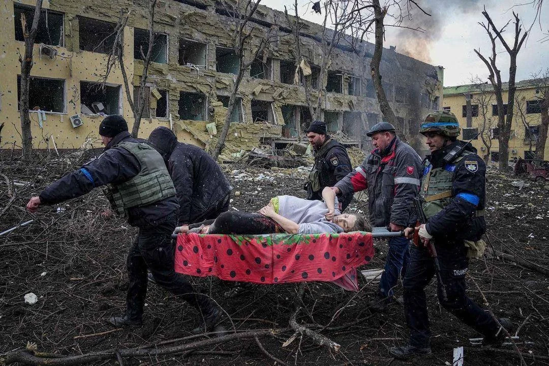 Рятувальники евакуюють поранену на носилках з руїн пологового будинку в Запоріжжі після удару РФ