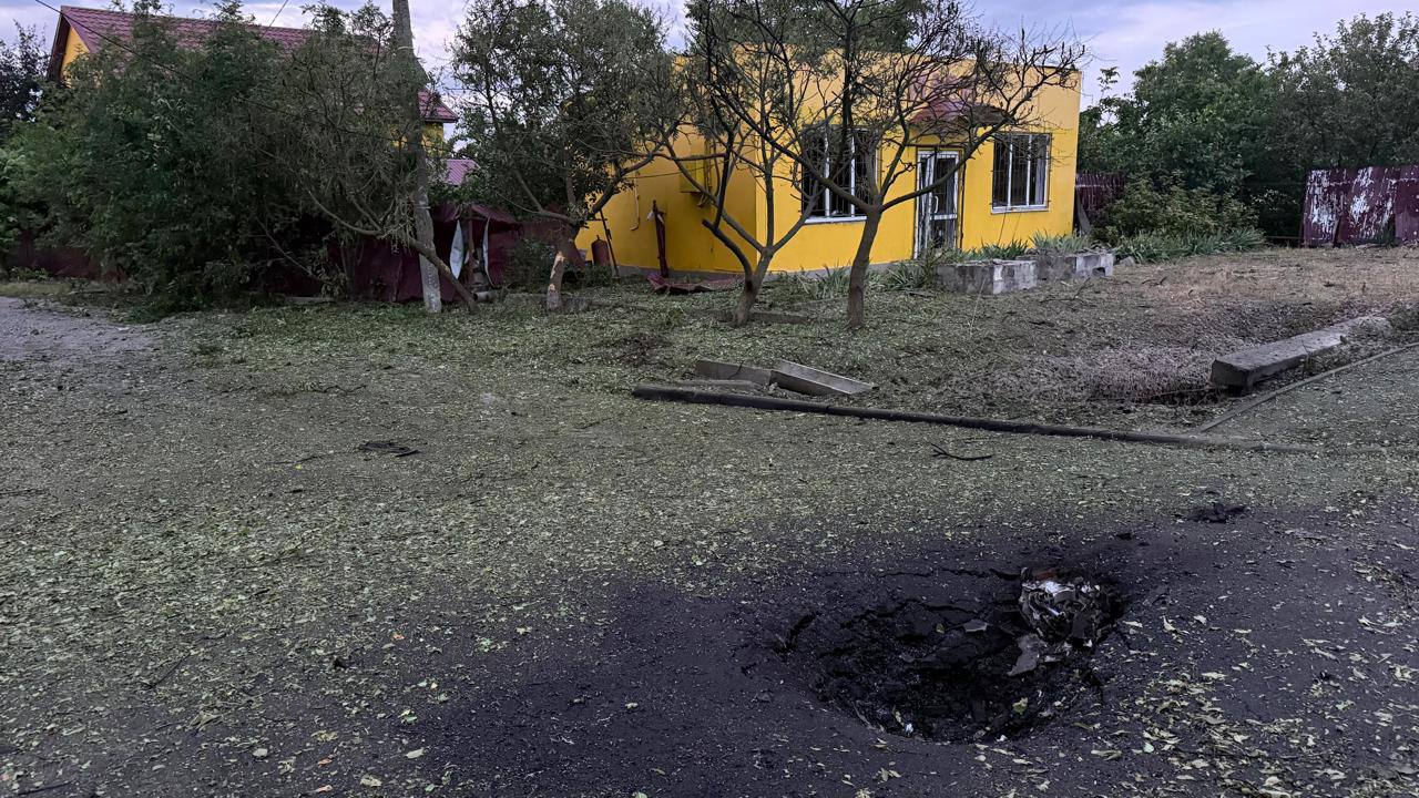 Воронка від удару КАБами біля пошкодженого будинку в Слатиному