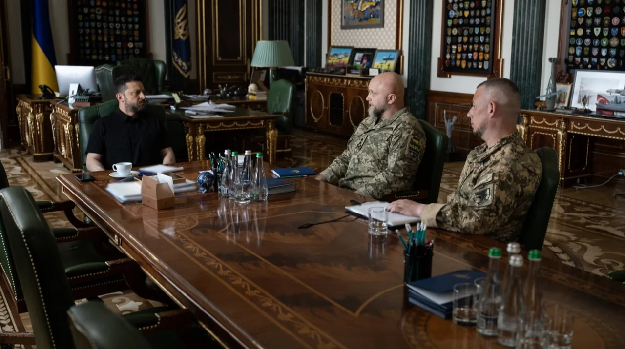 Володимир Зеленський проводить зустріч з військовим командуванням, зокрема з Драпатим, у робочому кабінеті.